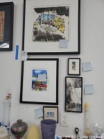 All five framed artworks displayed on wall