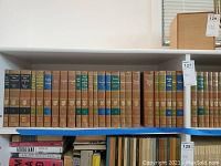 Shelf with 27 volumes of the Britannica Great Books in brown and green hardbound cases, showing some titles and volume numbers from 1 to 27.