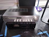 Yamaha R-700 receiver on top of Yamaha K-600 cassette deck, showing front panel with buttons and knobs
