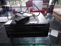 Full front view of Pioneer Elite VSX-07TX receiver with remote control on top, showing front panel and control buttons