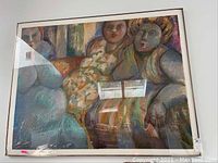 Straight-on view of framed wall art showing three figures