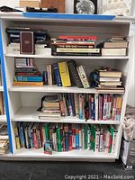Full bookshelf filled with various books including travel and foreign language titles