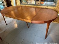 Full view of extension table with leaves installed, showing overall shape and style