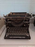Front view of Underwood typewriter showing keyboard and front panel with brand name.