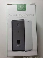 Front of retail box showing Owlet Home Smart Dog Camera and treat tossing feature