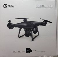 Front of drone box showing Holy Stone HS100 GPS FPV drone with 120 degree wide angle 2K HD Wi-Fi camera and specs including GPS, 600m flight range, 18 mins flight time