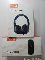 Photo of the Tribit XFree Tune headphones and Tribit StormBox speaker in their retail boxes.