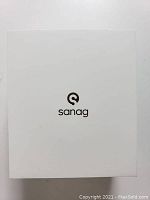 Closed white box with Sanag logo on lid.