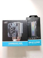 Boxed DeepCool GAMMAXX 400 CPU cooler and GH-01 A-RGB GPU holder, showing front packaging