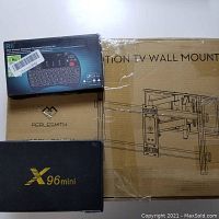 Perlesmith large full-motion TV mount box with visible model PSLFK1, X96 mini TV box, and Rii mini wireless keyboard combo packaging together.