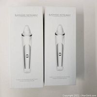 Two sealed boxed blackhead instruments, front view of packaging showing the device image and label 'BLACKHEAD INSTRUMENT'