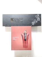 Top view of KIPOZI branded black box and rose pink automatic hair curler box with product image and branding