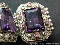 Close-up of central sterling silver panel with faceted rectangular purple amethyst stone and surrounding pink and green glass accents