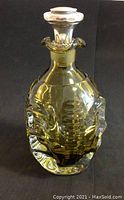 Front view of amber glass decanter with sterling silver collar stopper