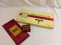 Photo of Monopoly and Sorry game boxes, showing the vintage packaging with wear and discoloration