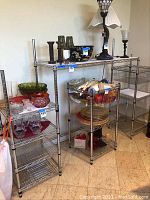 Full view of assembled multi-shelf chrome wire rack shelving unit on tiled floor, showing multiple shelves with no contents.