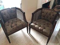 Pair of cane armchairs shown side by side, displaying overall condition and style
