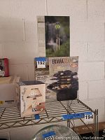 Photo showing tabletop fountain box, wind chime box, and small lamp box on wire shelf