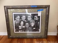 Front view of framed lithograph artwork showing group of children