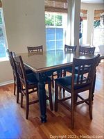 Full view of table and six chairs arranged in dining area