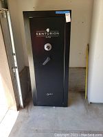 Exterior front view of closed black Centurion Explorer safe showing combination dial and handle