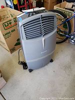 Front view of cooler in storage area on caster wheels