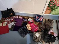 Full assortment of purses and bags showing variety of colors, styles, and sizes