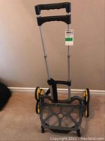 Front view of UpCart trolley showing adjustable handle and foldable base with six wheels.