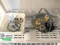 Full view of entire lot showing jewelry in white tray, metal trays and pill boxes with men's rings.