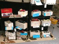 Wide view of multiple wire grid storage cubes assembled showing grids, edges, birdcage style shelves, and various stored model cars and boxes (contents not included).