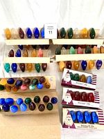 Full assortment of vintage GE Christmas light bulbs arranged in rows and some in original packaging.