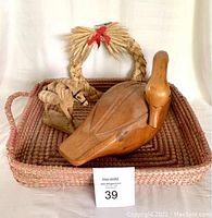 Set of carved wooden duck, carved wooden donkey, woven tray, and braided wreath