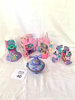 Overview of five colorful vintage Fairy Winkles playset pieces including castle compartments and a compact with pump.