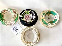Top view of all four teacup sets arranged together showing cup interiors and saucer patterns.