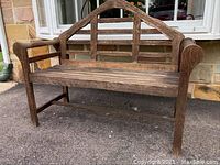 Front view of wooden garden bench showing slatted seat and triangular frame backrest with weathered wood.