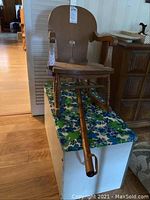 Child's wooden rocker chair on floral toybox