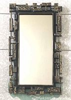Full front view of rectangular mirror showing complete Brutalist-style frame.