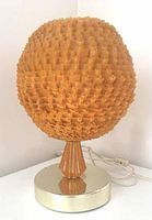 Front view of vintage mid century modern orange lucite spaghetti lamp with gold tone base and original cord.