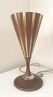 Full view of vintage mid century desk lamp showing conical fiberglass shade with wood grain stripes, walnut wood base and narrow neck, original cord and plug.