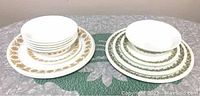 Overall view of the two Corelle patterns showing stacks of plates and bowls