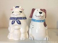 Both cookie jars side by side, cow and dog shaped, showing full front view