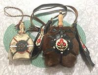 Two vintage Hungarian folk art horse hair and leather flasks/canteens laid flat on a surface, showing front and detail.