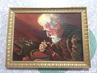 Framed oil painting showing profile of elderly man with white hair and beard, holding grapes near a table with eyeglasses and fruit, lit from left.