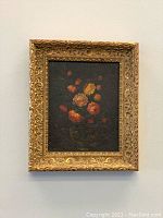 Full front view of the framed watercolour flower painting with dark background and warm toned flowers.