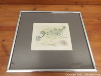 Framed abstract drawing "Le Passage" showing the overall presentation with gray mat and silver frame on a wooden surface.