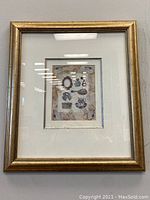 Framed print showing entire artwork in gold frame with cream matting