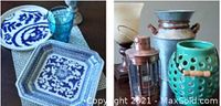 Overview photo showing all items: two blue and white decorative plates, a silver goblet, two lanterns including a turquoise ceramic one and a copper lantern, a small table lamp, and a rustic metal vase.