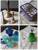 Photo showing metal playing card themed tin container, blue glass candle holders, and colored glass decorative pieces including green bell and small figurine