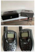 View of two metal lock boxes on a glass table, one black and one grey with metal handles and key locks.