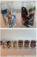 Two Burger King collectible glasses with Star Wars Empire Strikes Back characters C-3PO, R2-D2, Darth Vader, Boba Fett